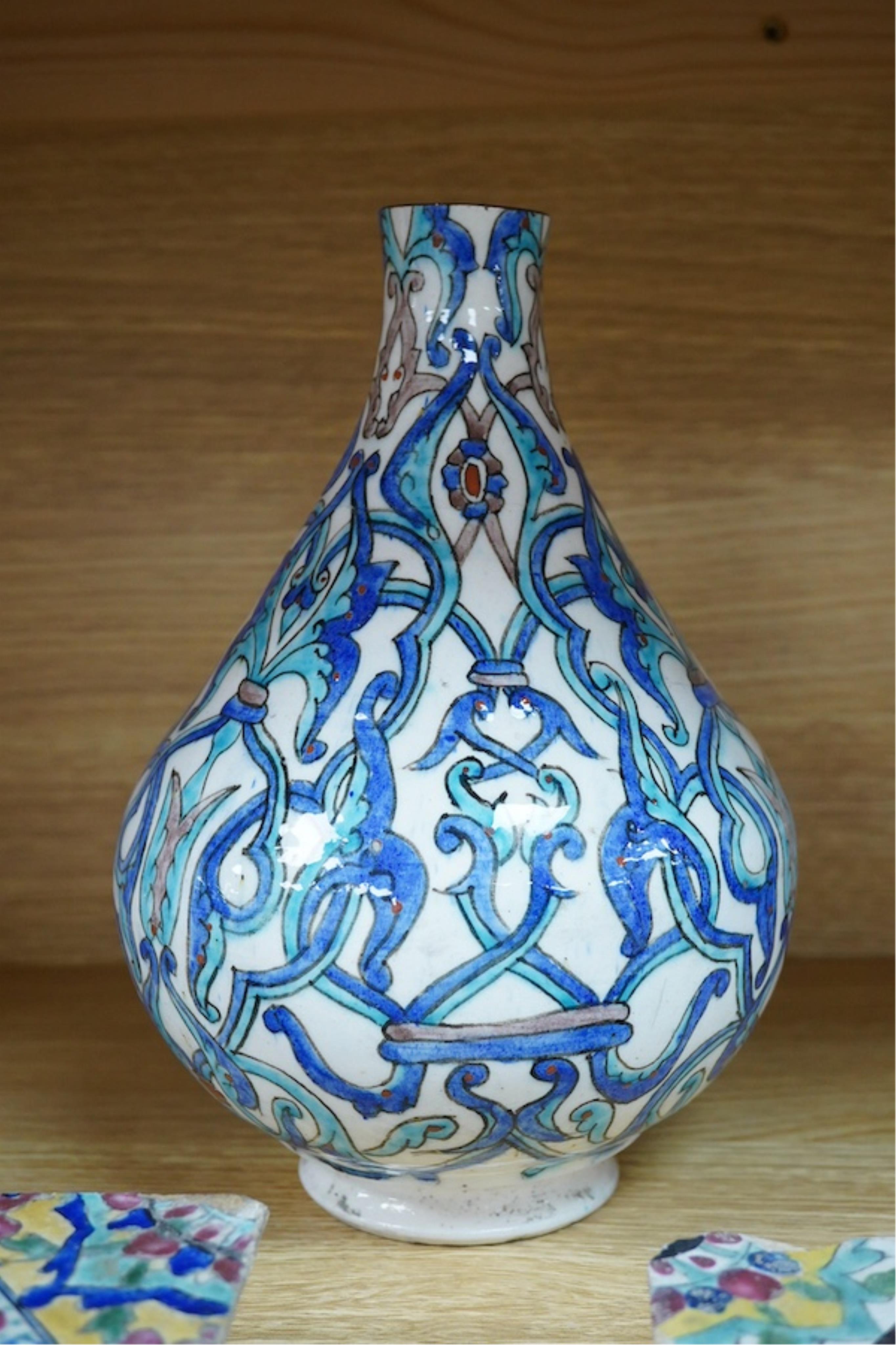 A Persian stoneware vase (reduced) and two floral tiles